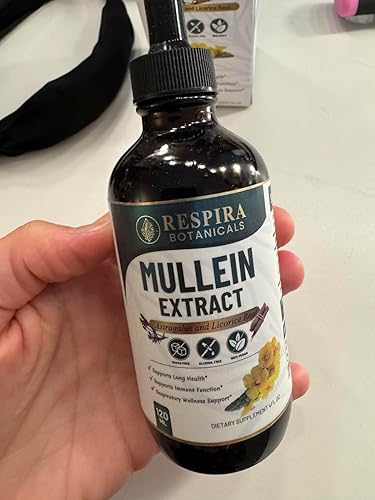 Bottle of Resplora Botanicals Mullein Extract held in a hand on a white surface.